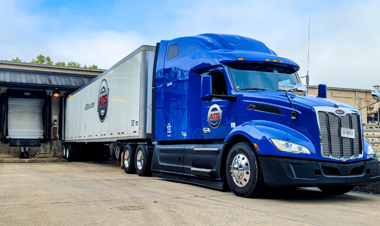 An ATS truck tractor and dry van trailer at a loading dock.