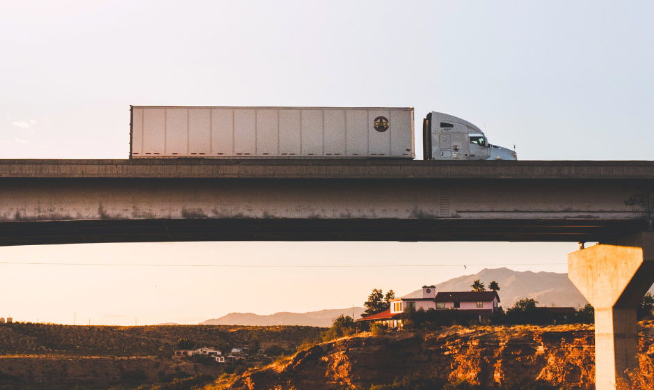 A semi truck travels on an overpass