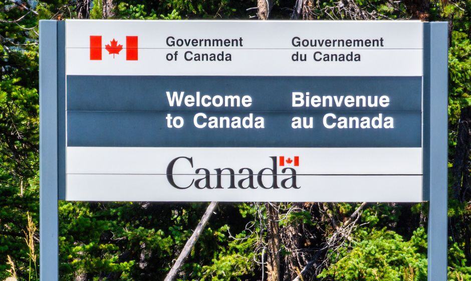 A sign welcoming traffic into Canada after crossing the border 