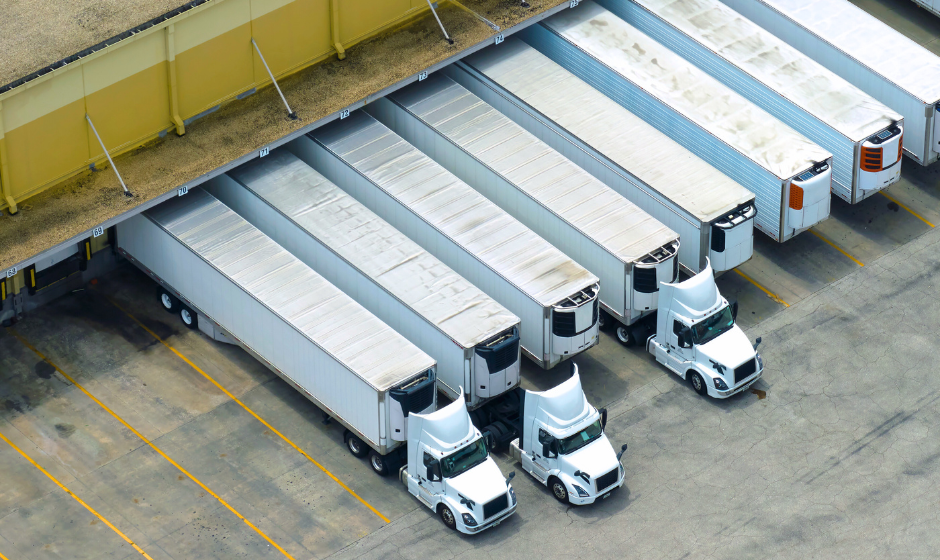 Dry van trucks and trailers at a distribution center