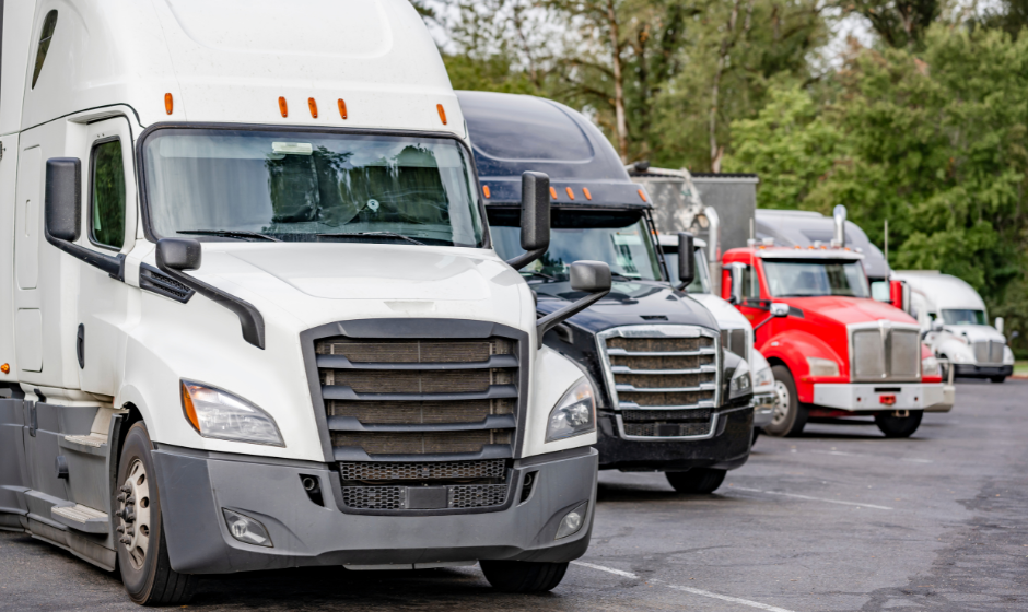 Multiple semi trucks parked.