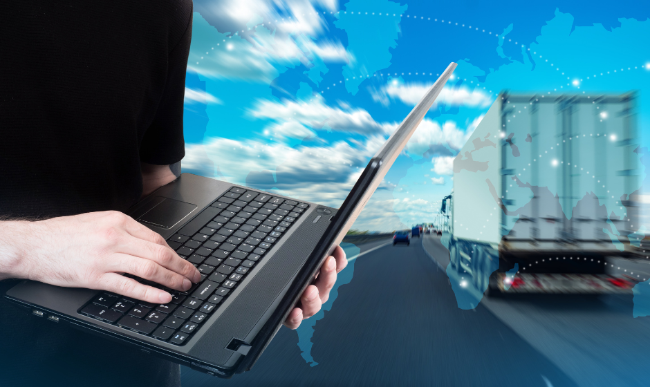 Laptop and semi truck against background of world map