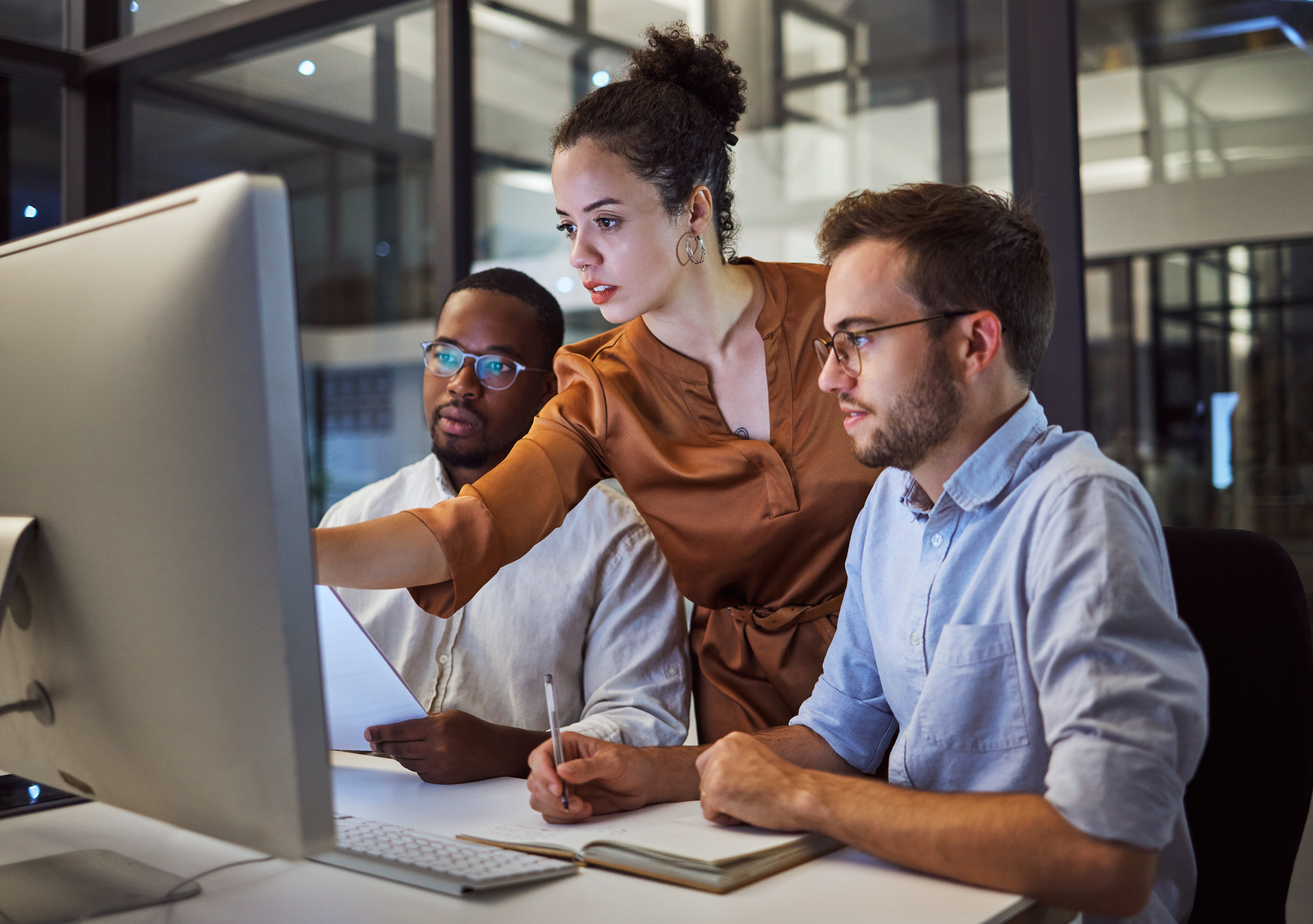 Three coworkers review a customer portal