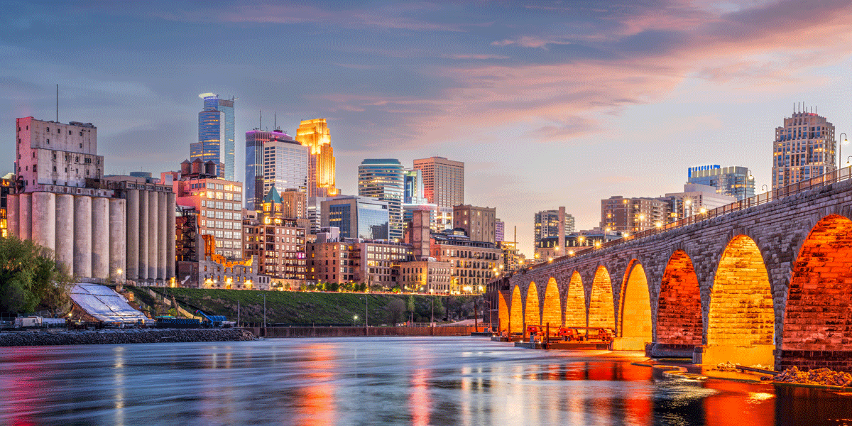 Minneapolis skyline near the river at sunset.